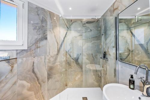 a bathroom with a shower and a sink at Hotel San Carlu Citadelle Ajaccio in Ajaccio