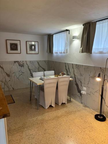 a dining room with a table and two chairs at da Melina in Parma