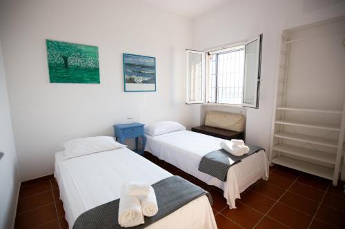 a room with two beds and a window at SeaSide Paradise - Seafront Terrace Apartment by BariHouses in Cozze