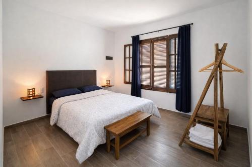 a bedroom with a large bed and a wooden ladder at Cabaña Regivan en Uspallata in Uspallata