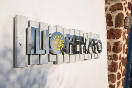 a sign for the colosseum on a wall at Ilioperato Hotel in Imerovigli
