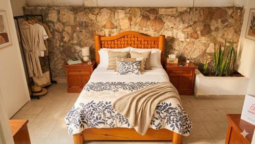 a bedroom with a wooden bed with pillows on it at Eco-Loft Ixtapan de la Sal in Ixtapan de la Sal