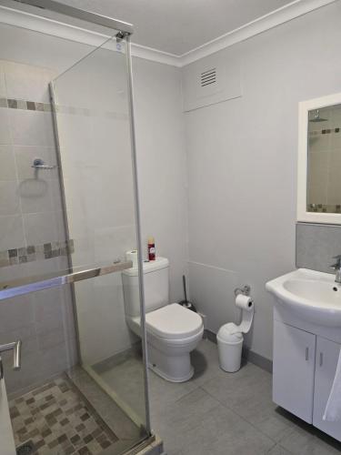 a bathroom with a toilet and a sink at Flat 108 Cozumel, Umdloti Beach Front in Umdloti