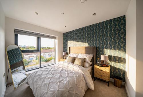 a bedroom with a bed and a large window at Luxury 2BR Penthouse-1, Private Terrace, City Center, Free Parking in Leeds