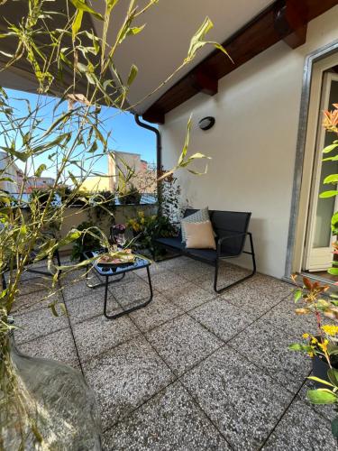 a patio with a couch and a table at Alba in Fiore in Alba