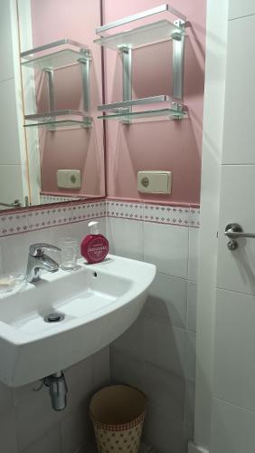 a bathroom with a sink and a mirror at Precioso Piso junto a Plaza de España in Seville