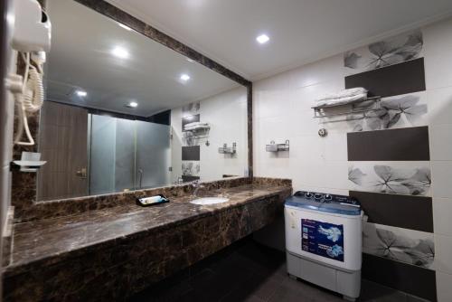 a bathroom with a sink and a mirror at Dar Hashim Serviced Apartments Al Morouj - Economic in Riyadh