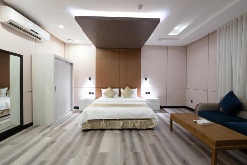 a large bedroom with a bed and a couch at Dar Hashim Serviced Apartments Al Morouj - Economic in Riyadh