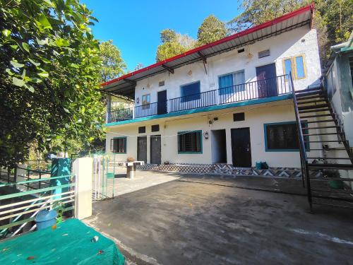 a house with a staircase in front of it at vishranti homestayy in Rishīkesh