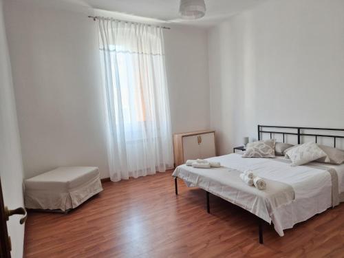 a bedroom with a large bed and a wooden floor at Punto Zero Ca' Trillina in La Spezia