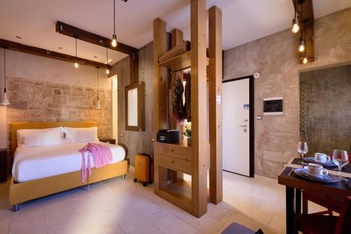 a bedroom with a bed and a desk in a room at Mamaco Trani Homey in Trani