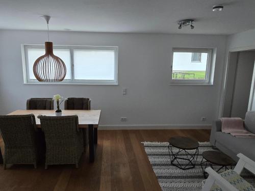 a living room with a table and a couch at Utting Schulstrasse in Utting am Ammersee
