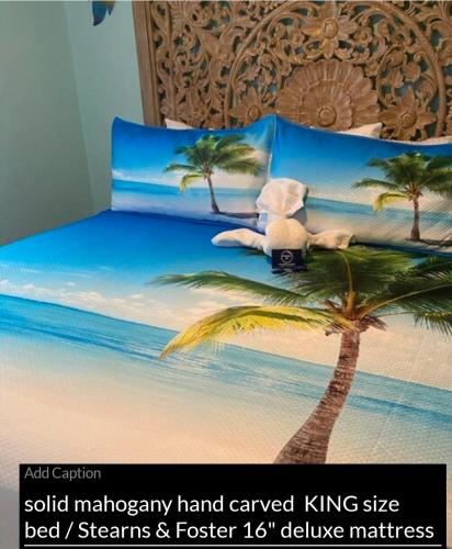 a bed with a teddy bear laying on top of a palm tree at The Monterey Beach Resort in St. Pete Beach