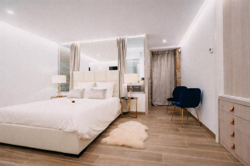a white bedroom with a large bed and a mirror at Casa Albarari Boutique Double Rooms with access to shared Infinity Pool in Sanxenxo