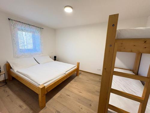 a bedroom with two bunk beds and a ladder at Apartmány Veselka in Oslnovice