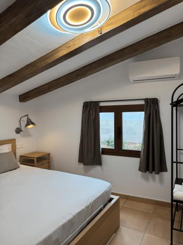 a bedroom with a bed and a window at Camping Fonts del Algar in Callosa d'en Sarrià