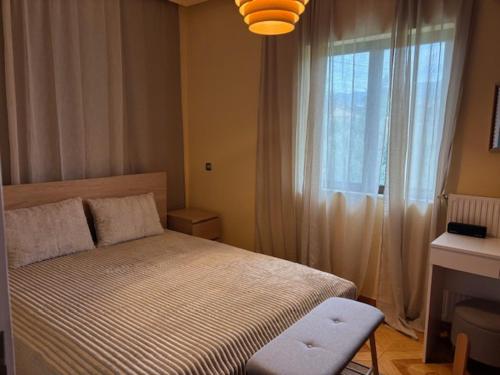a small bedroom with a bed and a window at Dream Village Mani in Karvelás