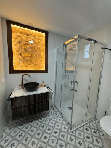 a bathroom with a shower and a sink at Camping Fonts del Algar in Callosa d'en Sarrià