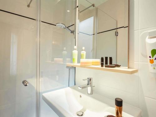 a white bathroom with a sink and a shower at ibis Styles Paris Nation Porte De Montreuil in Paris
