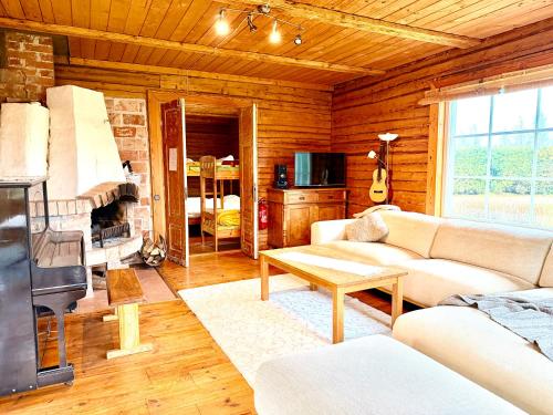 a living room with a couch and a table at Järve Talu Puhkemaja in Otepää