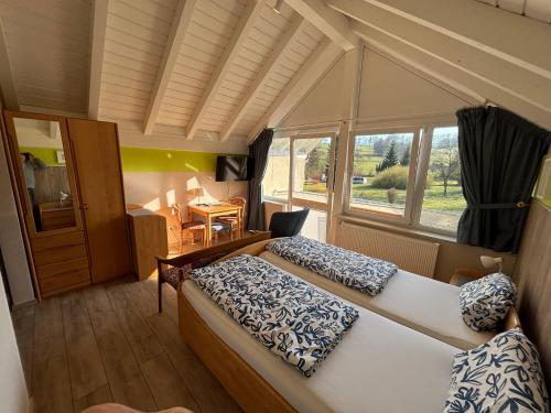 a bedroom with two beds and a window at Gästehaus Steker in Bad Driburg
