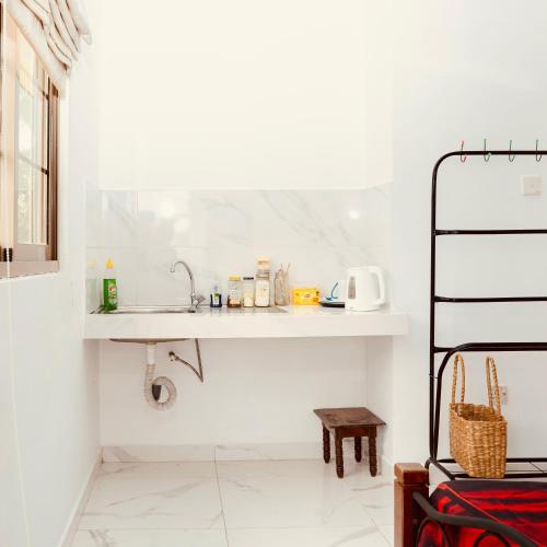 a white kitchen with a sink and a counter at hostel of sincerity Female only in Maharagama