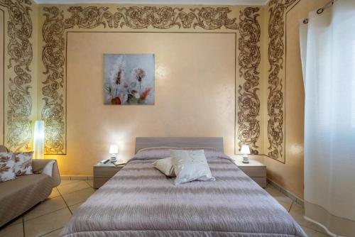 a bedroom with a bed and a couch at Relax House in Squinzano