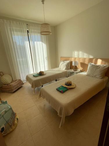 a hotel room with two beds and two tables at RochAlvor in Alvor