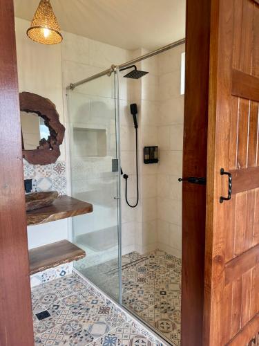 a shower with a glass door in a bathroom at Canela Mountain Villa Hotel in Salento