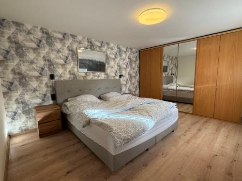 a bedroom with a bed and a stone wall at Bergmannsruh OG in Clausthal-Zellerfeld