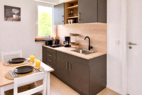 a small kitchen with a sink and a table at Wohnung in Siegen Parkplatz WLAN Autobahn in Wilnsdorf