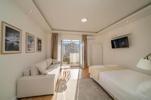 a living room with a bed and a couch at Sea Point Apartments Igalo in Igalo