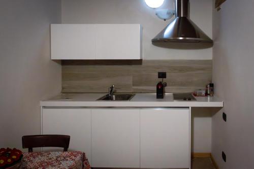 a kitchen with a sink and a white cabinet at Le Ortensie Lago di Garda in Monzambano