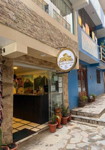 a store with a sign on the side of a building at Machu Picchu Sacred Valley in Machu Picchu