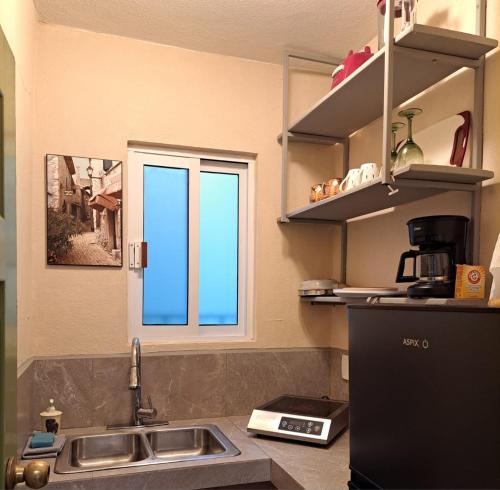 a kitchen with a sink and a window at Alojamiento Privado San Jose Viejo BCS in San José del Cabo