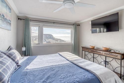 a bedroom with a blue bed and a window at Fun Times At Nye Beach in Newport