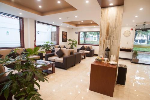 a living room with couches and tables and plants at Royal Inn Cusco Hotel in Cusco