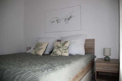 a bedroom with a bed with pillows on it at Auszeit in Bad Dürkheim