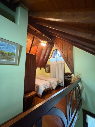 a bedroom with a bed in a room with wooden ceilings at Rincón del Cielo Country Club in Merlo