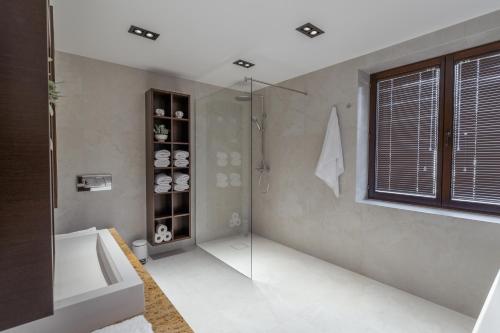 a bathroom with a shower and a glass shower stall at The One Wadowice in Wadowice