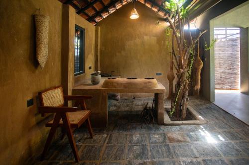 a bathroom with a sink and a table and a chair at The Yala Lodge in Kirinda