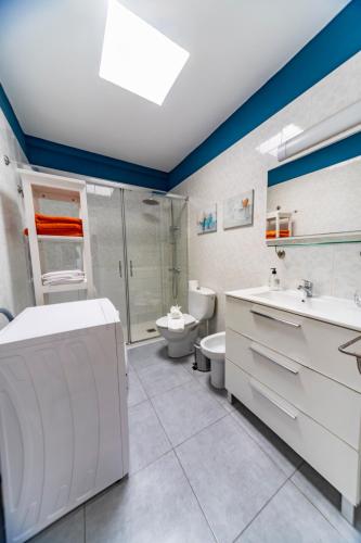 a bathroom with a sink and a toilet and a shower at Luxury Suite Sea Front III in Playa Honda