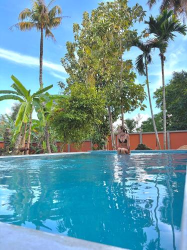 a woman in a bikini sitting in a swimming pool at MAYA Ahangama in Ahangama