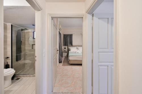 a bathroom with a toilet and a bed in a room at Mani Villa Ilias in Agios Nikolaos