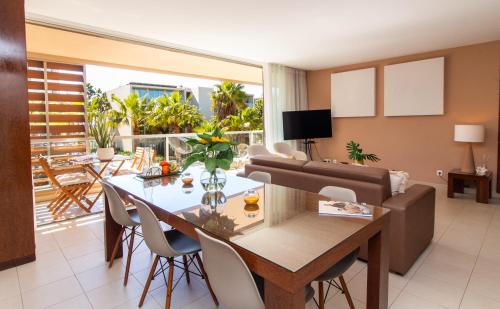 a living room with a dining table and a couch at Herdade dos Salgados Beach apartment in Albufeira