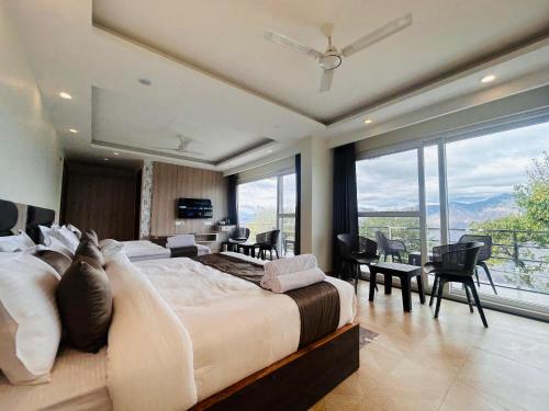 a large bedroom with a large bed with a view at The Hill Heaven A Luxury Property With Balcony & Mountain View Rooms in Mussoorie