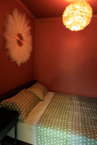 a bedroom with a bed and two lights at Heathrow Royal Apartment in Ashford