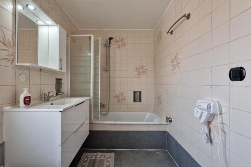 a bathroom with a tub and a sink and a shower at Villa jolly mini appartament in Marghera