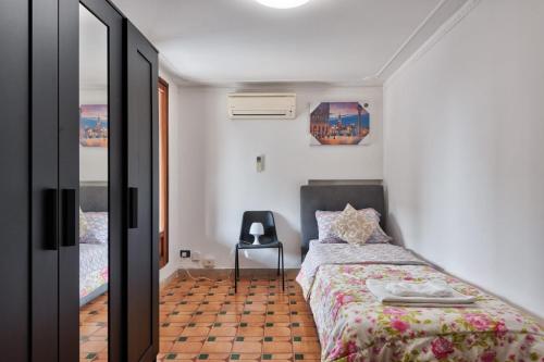 a bedroom with a bed and a table in it at Villa jolly mini appartament in Marghera