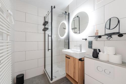 a white bathroom with a sink and a shower at Bergnest Iseler mit Panoramablick in Oberjoch